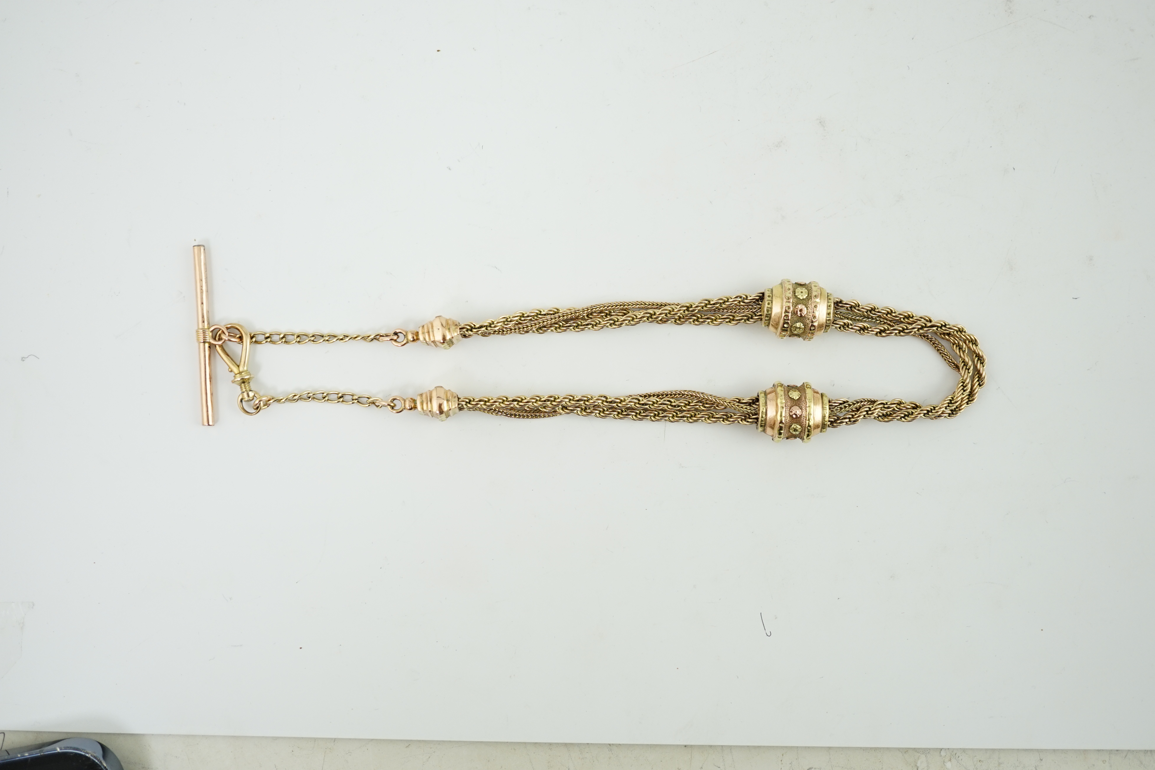 A Victorian two colour gold triple strand Albertina